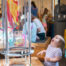 A toddlers exclaims joyfully while watching a craft fly in the translucent tube of the WonderLab HoverCrafts exhibit.